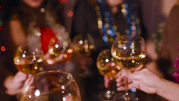 Young women colleagues at a corporate or Christmas party clink glasses of champagne — Stock Video