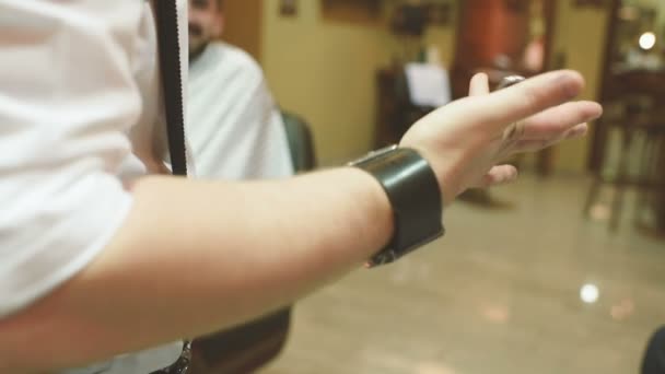Barber or hairdresser turns scissors on finger — Stock Video