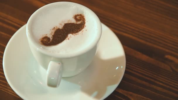 Drawing on the foam of coffee or latte art in the form of a mustache close — Stock Video