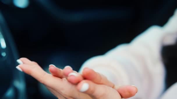 Close up view and slow motion video of females hands using spray for disinfection. Take care of hands using spray for cleaning. Girl sit in car during travelling break. — Stock Video