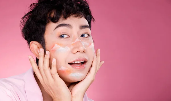 Half Body Portrait of 20s Asian man black hair pastel sweet dress. Gay wear fashion style and poses over pink Background isolated