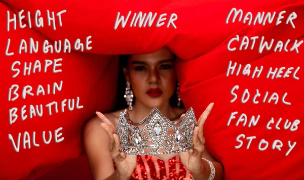 Asian Indian Woman hold winner diamond crown with Red cloth fluttering throw back in Air, Concept Miss Beauty Queen with many Ability Quality for Winner Prize such as language, height, shape, etc