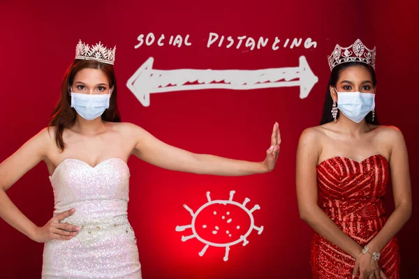 Group of Two Miss Beauty Queen Pageant Contest apply New Normal style to all contestant by wearing Protective Face Mask, Diamond Crown. Concept Social Distancing, Red Tone Background copy space