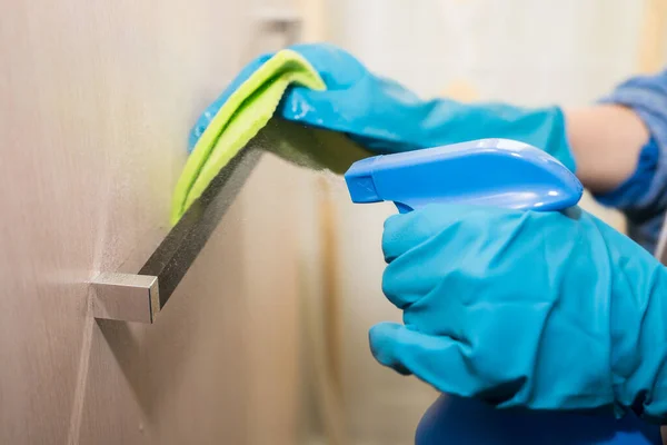 A girl in gloves disinfects the surface with a sanitizer antiseptic. Royalty Free Stock Images