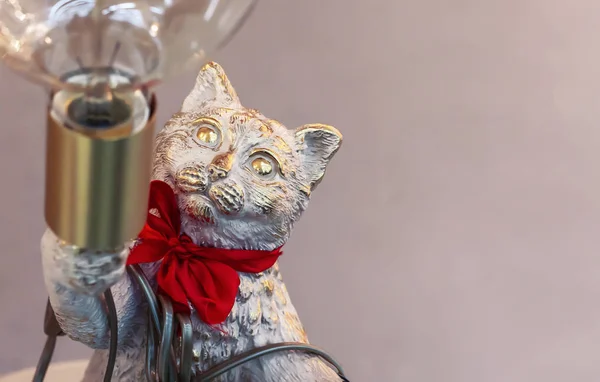 Bronze statuette of a cat with a lamp.