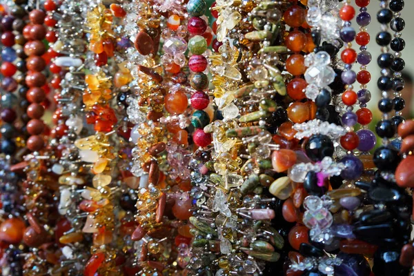 Jewelry made of natural stones in a street shop. — Stock Photo, Image