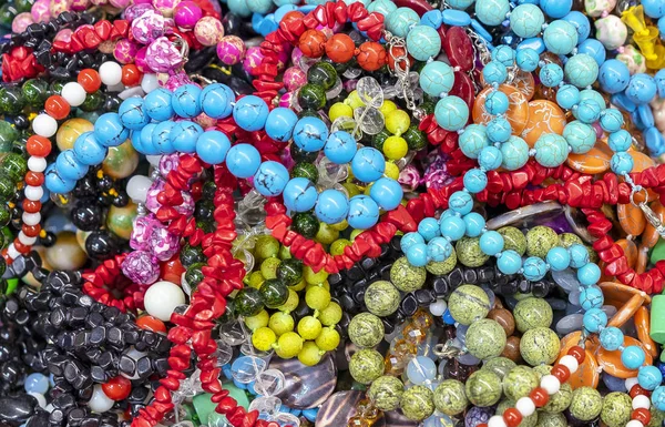 Jewelry made of natural stones in a street shop. — Stock Photo, Image