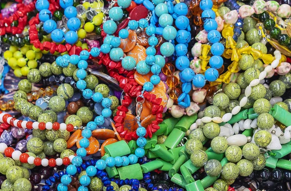 Jewelry made of natural stones in a street shop. — Stock Photo, Image