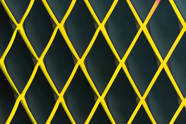Yellow diamond-shaped lattice against a dark background.