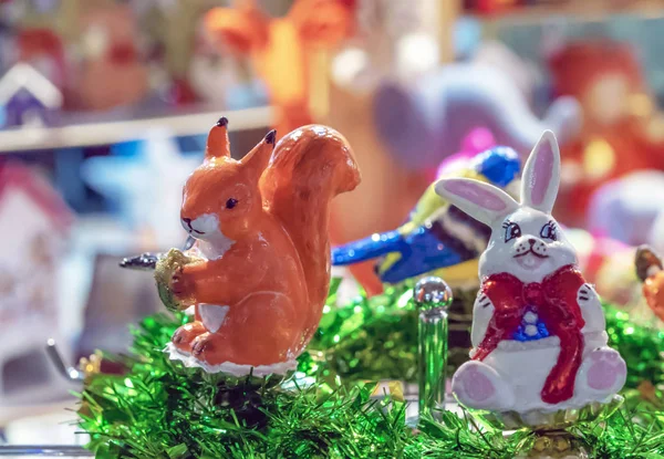 Squirrel with a nut. Glass Christmas toys. — Stock Photo, Image