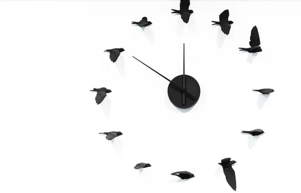 Horloge en quartz avec des oiseaux noirs sur un mur blanc . — Photo