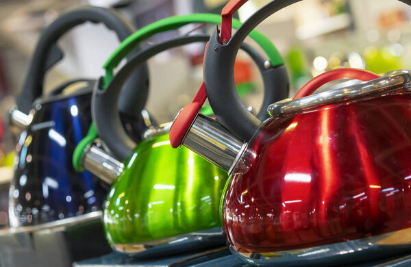 Metal kettles with a whistle of various colors.