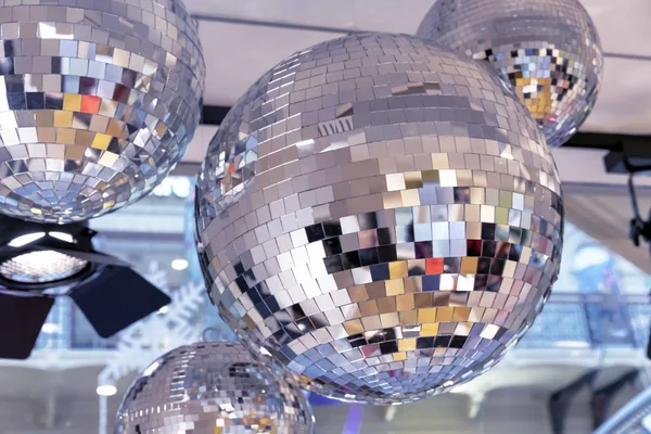 Mirror disco balls and a searchlight on a New Year\'s background.