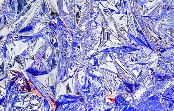 Aluminum foil with multi-colored illumination . Background and texture of aluminum foil. — Stock Photo, Image
