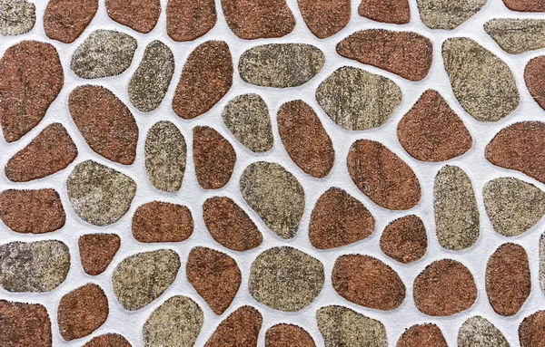 Porcelain tile with a pattern of stones of different shapes and sizes. Background of stones.