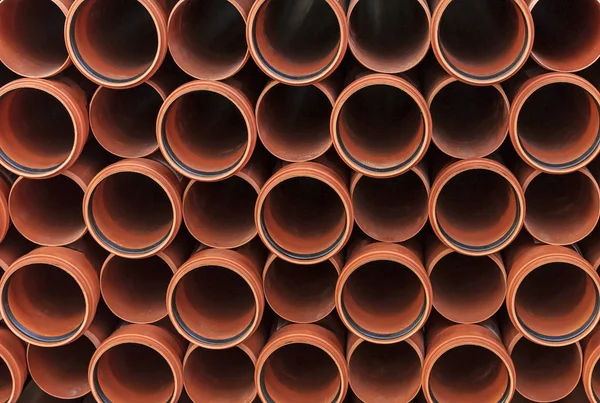 Orange sewer pipes. Background from plastic pipes.