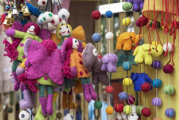 Felt toys. Bright woolen toys in the showcase of a gift shop.