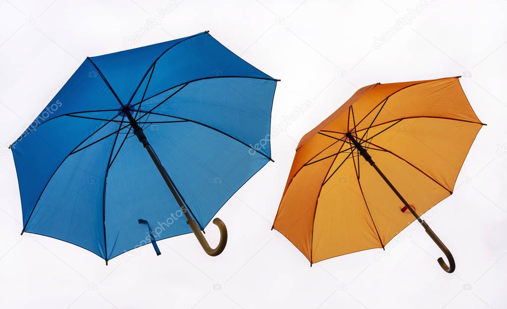 Two colorful umbrellas on a white background.