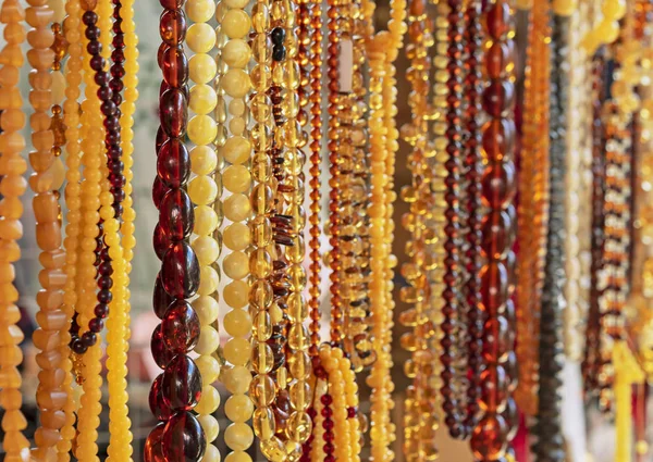 Amber background of beads. Amber beads in a jewelry shop window. Jewelry design.