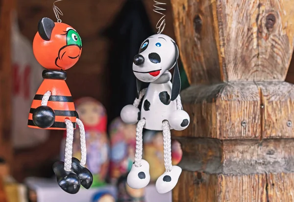 Wooden toys dog and cat on the street market.