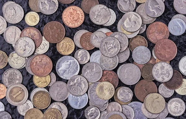 Coins of different countries of the world. A collection of old and modern coins. Background from metal coins. — Stock Photo, Image