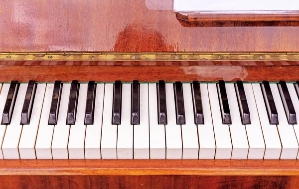 Tastatur auf einem braunen Klavier. Schwarz-weiße Tasten auf der Tastatur des alten Klaviers. — Stockfoto