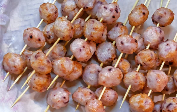 Balls with an octopus on wooden skewers. National Vietnamese dish. — Stock Photo, Image