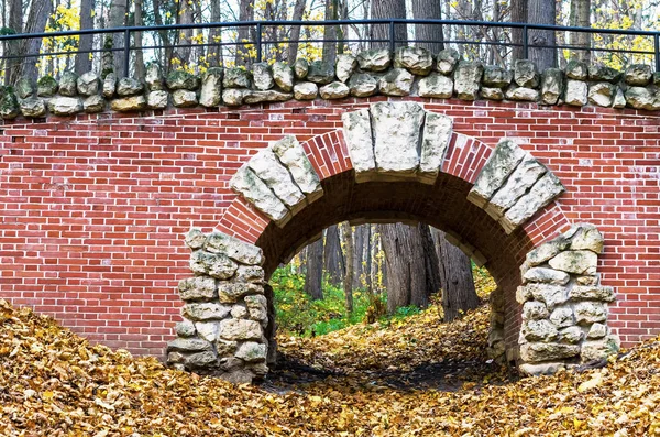 Autumn. Old brick arch overlooking the Autumn Park.
