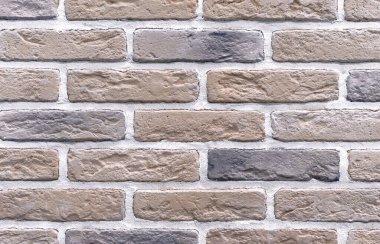 Bej tuğlalardan bir duvar. Tuğla işçiliğinin arkaplan ve dokusu.