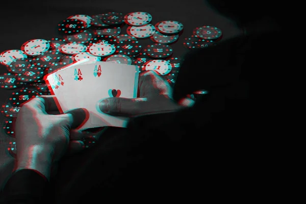 mens hands hold cards , a set of aces on the background of playing chips. Black and white with 3D glitch virtual reality effect