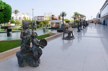 SHARM EL SHEIKH, EGYPT - MAY 9, 2018: Sculptural compositions in popular shopping and entertainment complex of Soho Square, Sharm El Sheikh, Egypt  clipart