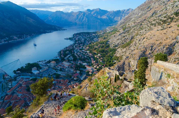 Tourists are at ancient fortress walls above Kotor and Bay of Kotor, Montenegro — Stock Photo, Image