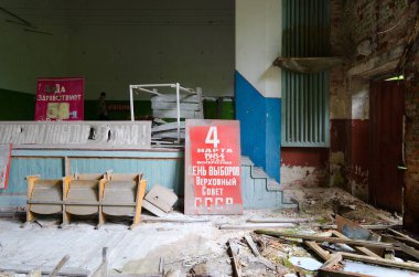 Beyaz Rusya 'nın Çernobil sınırlama bölgesindeki Pogonnoye köyündeki eski Kültür Evi' nin terk edilmiş binasında sosyalist sloganlar taşıyan posterler. Posterler üzerine yazı: 4 Mart 1984 Pazar günü SSCB Yüksek Sovyet seçimleri var.