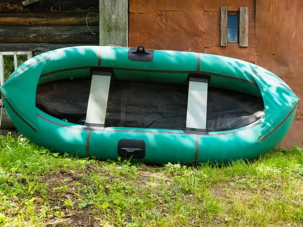 Kulübeye Yaslanmış Yeşil Lastik Bir Tekne — Stok fotoğraf