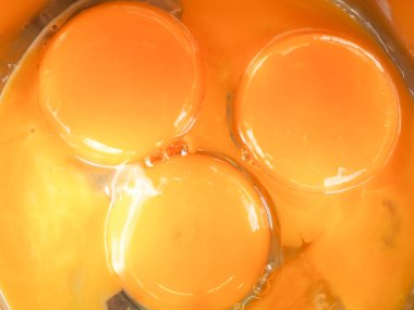 Bir kasede üç yumurta sarısı. Kahvaltı pişir. Sarıdan yapılmış bir gülümseme..