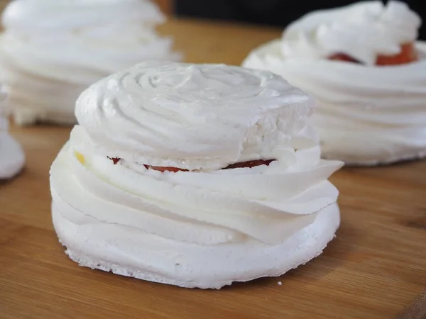 a pastry chef prepares a meringue cake. Anna Pavlovna\'s Dessert. meringue with cream. cooking process.