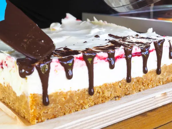 the pastry chef decorates the cake with melted chocolate. chocolate. cook.
