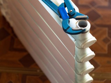 Fındıkları radyatördeki ayarlanabilir anahtarla çevir. Eve radyatör yerleştiriliyor.