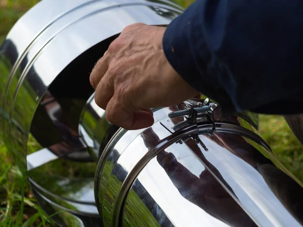 Saptırıcıyı ısıtma borusuna yerleştiriyorum. Sandviç piposu. İnşaat. Eller çerçevede.