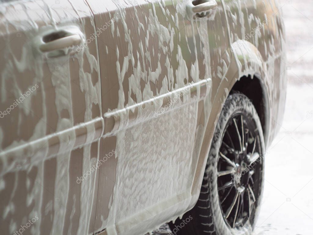machine in the foam from car shampoo. self-service car wash. dripping foam.