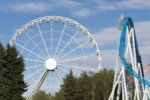 Ferris wheel and roller coaster in the amusement Park. The city of St. Petersburg Divo Ostrov.