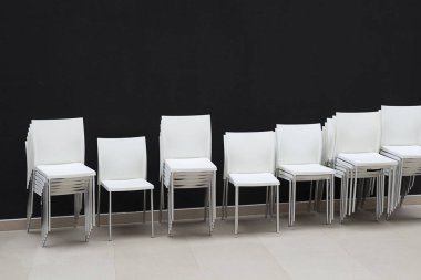 Siyah beyaz plastik sandalyeler çok arka plan duvar. Mobilya her aptal mı.