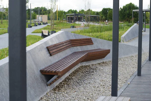 Wooden concrete bench in the Park on a summer day.