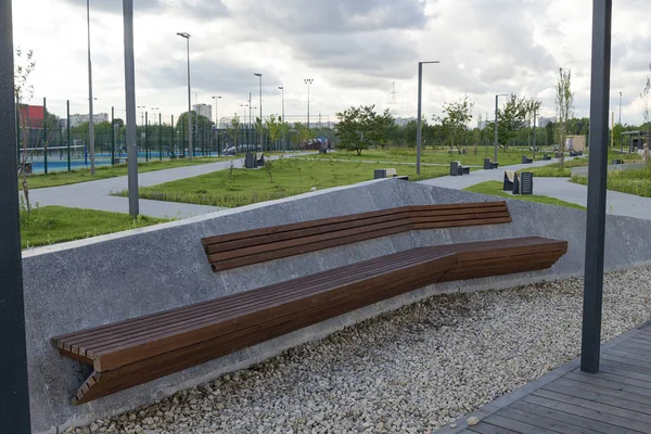 Wooden concrete bench in the Park on a summer day.