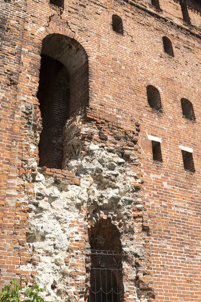 Destroyed brick wall with Windows. Abandoned old building to be demolished.