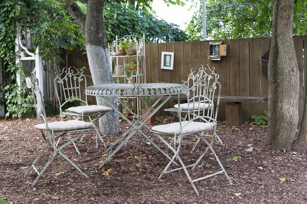 Classic furniture, metal table chairs in the summer Park in good weather.