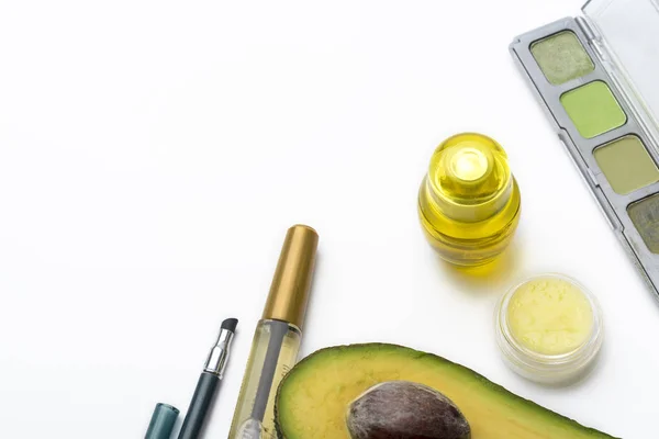 Natural herbal skin care products, top ingredients, avocado, isolated background makeup brushes for face and cosmetic products. Preparation facial skin care.
