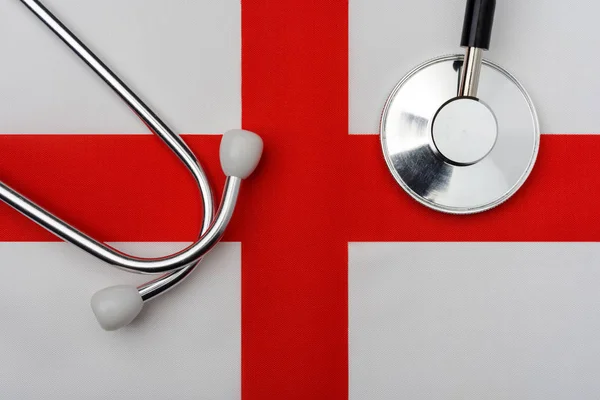 The flag of the English Kingdom and a stethoscope.