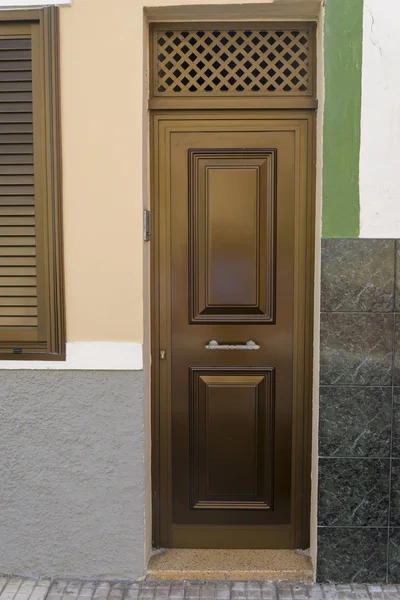 Closed metal brown door in a residential building. Stock Photo