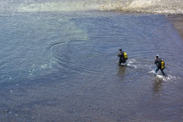 Two divers go to sea on the island of Tenerife.